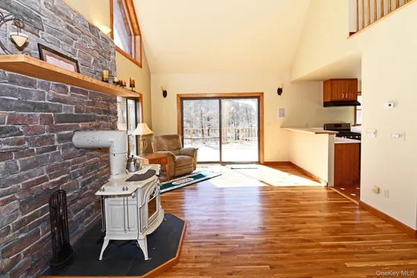 a living room with fireplace furniture and a wooden floor