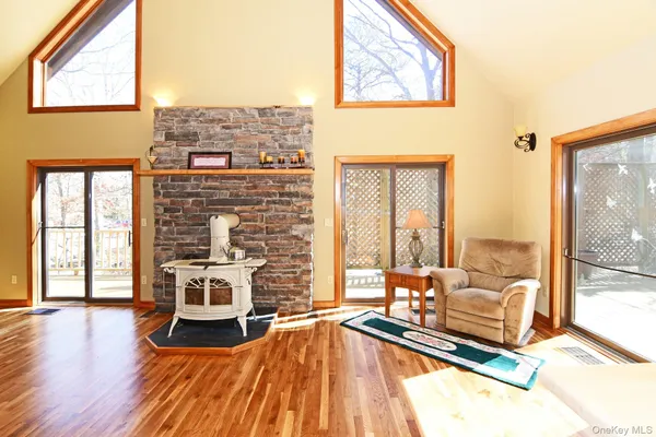 a living room with furniture fireplace and wooden floor