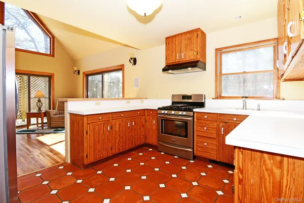 a kitchen with granite countertop a sink and wooden cabinets