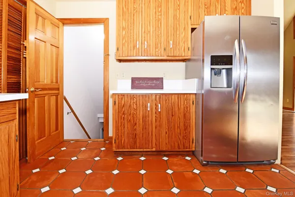 a kitchen with a refrigerator and window
