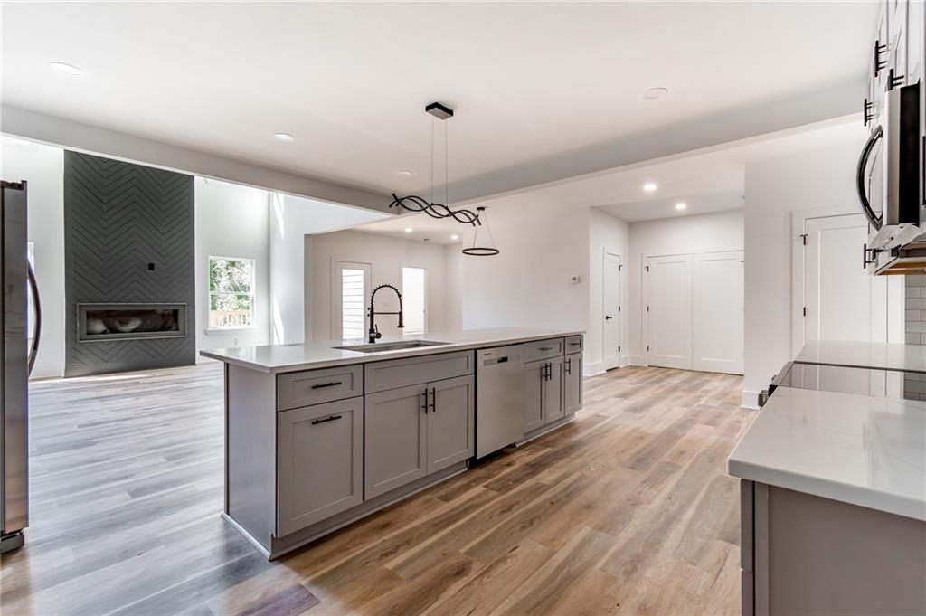 6121 Timberidge Drive Gainesville, GA 30506 - Photo 12 of 44 a large kitchen with a lot of counter space and wooden floor