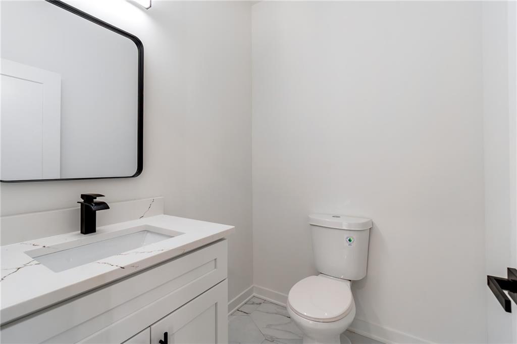 6121 Timberidge Drive Gainesville, GA 30506 - Photo 17 of 44 a bathroom with a toilet sink and mirror
