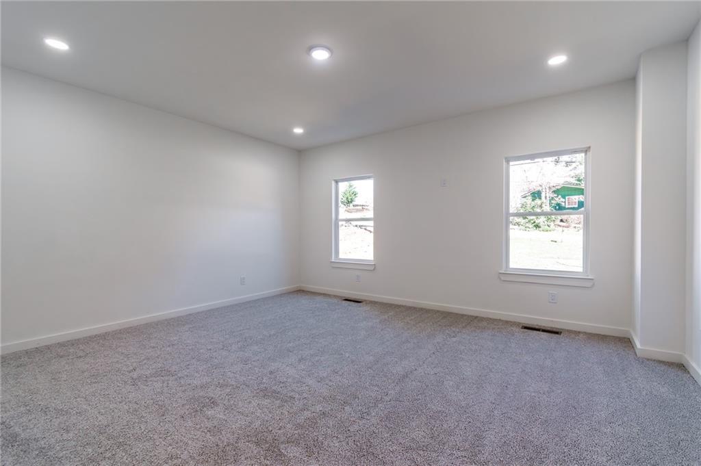 6121 Timberidge Drive Gainesville, GA 30506 - Photo 26 of 44 an empty room with windows