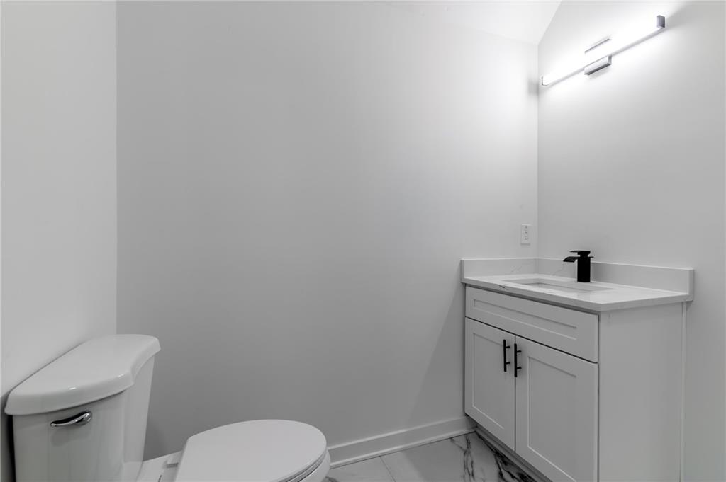 6121 Timberidge Drive Gainesville, GA 30506 - Photo 28 of 44 a bathroom with a toilet sink and mirror