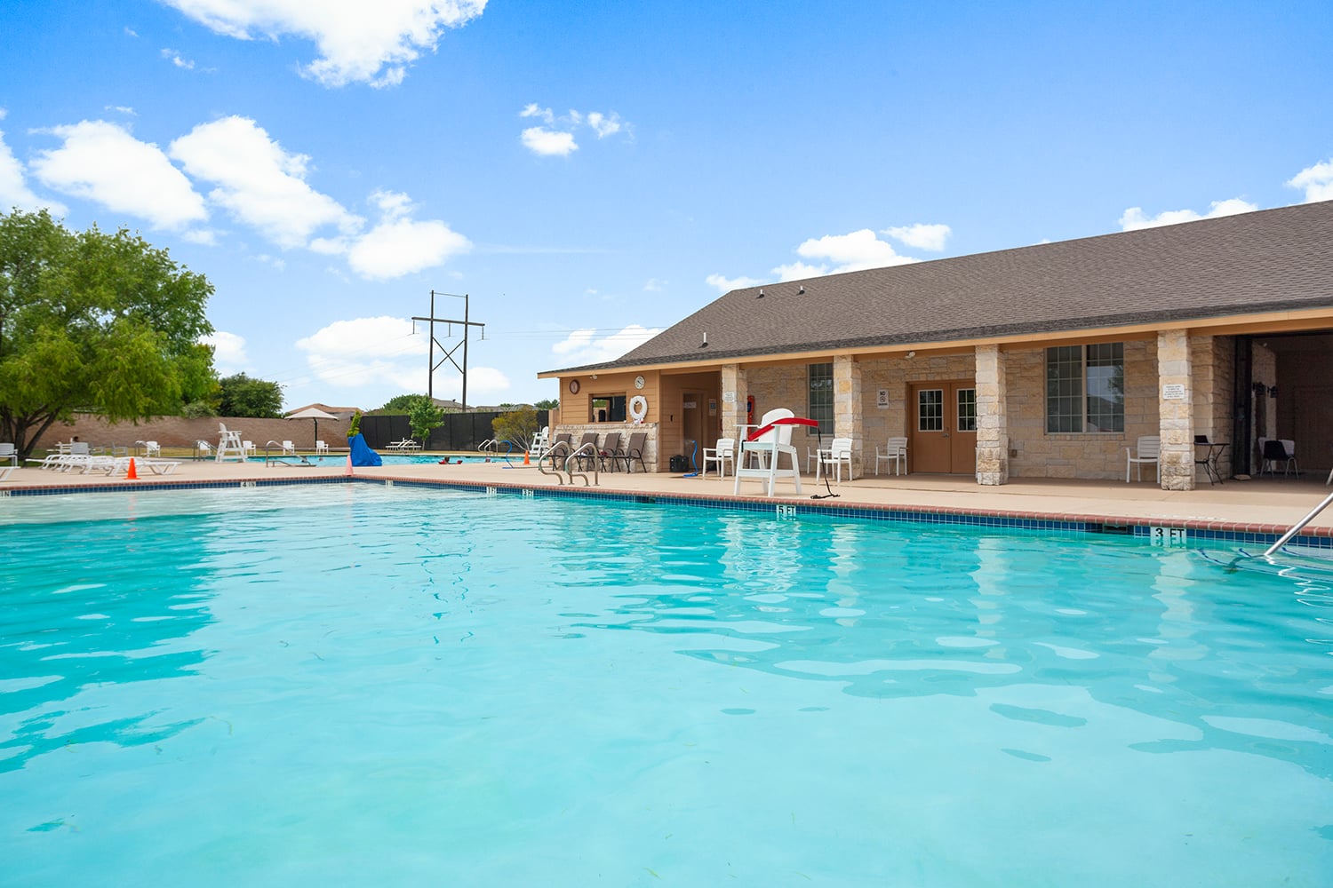 252 Firefox Way Jarrell, TX 76537 - Photo 5 of 11 A refreshing outdoor pool with a clubhouse provides an inviting community gathering space.