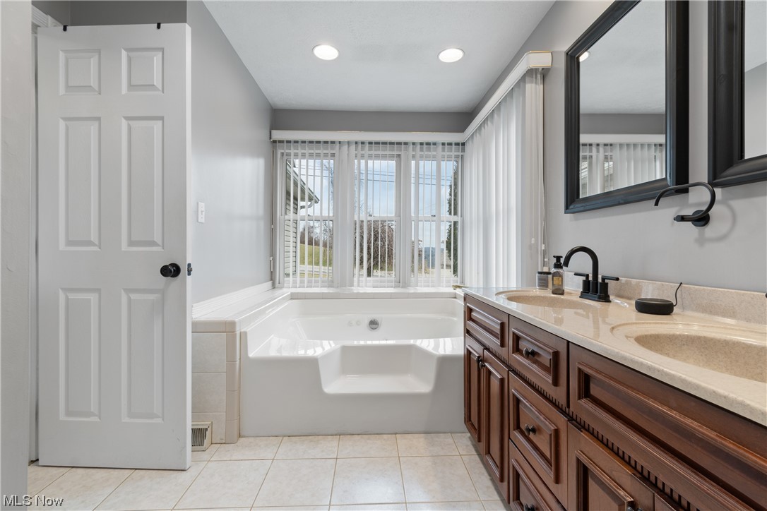 53330 High Ridge Road Bridgeport, OH 43912 - Photo 17 of 34 Bathroom featuring double sink vanity, a bath to relax in, and tile flooring