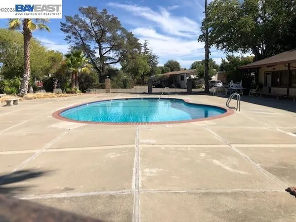 a view of a swimming pool with outdoor seating