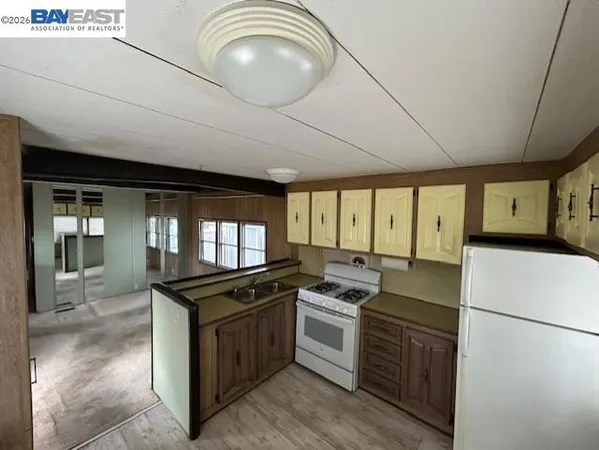 a kitchen with a stove a sink and a refrigerator