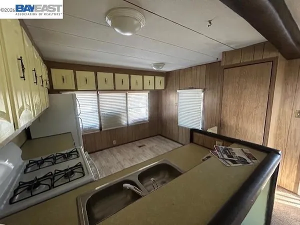 a living room with hard wood floor and a window