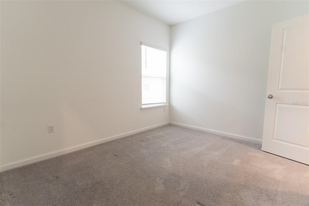 4501 Northwest 14th Loop Ocala, FL 34482 - Photo 11 of 38 an empty room with a window