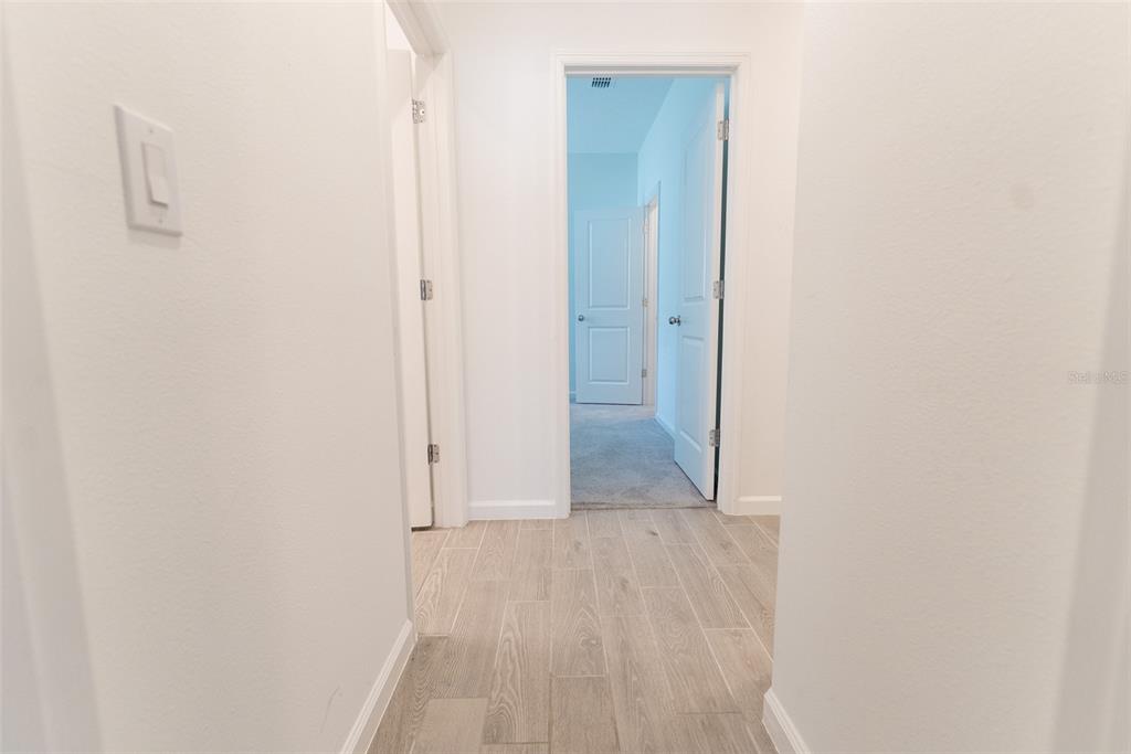 4501 Northwest 14th Loop Ocala, FL 34482 - Photo 16 of 38 a view of a hallway with wooden floor
