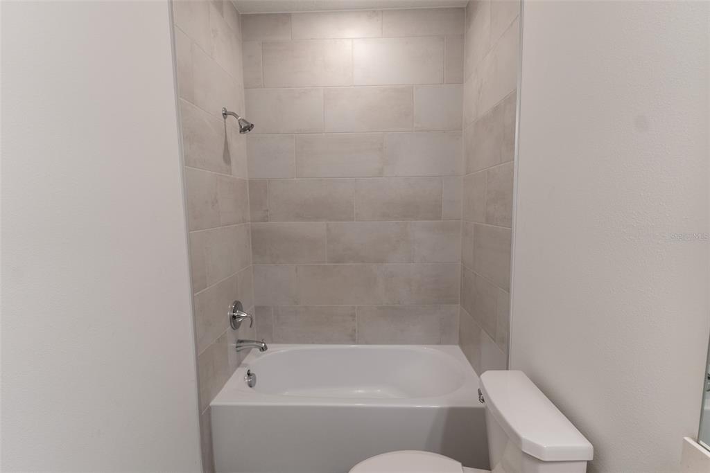 4501 Northwest 14th Loop Ocala, FL 34482 - Photo 17 of 38 a bathroom with a bathtub and toilet