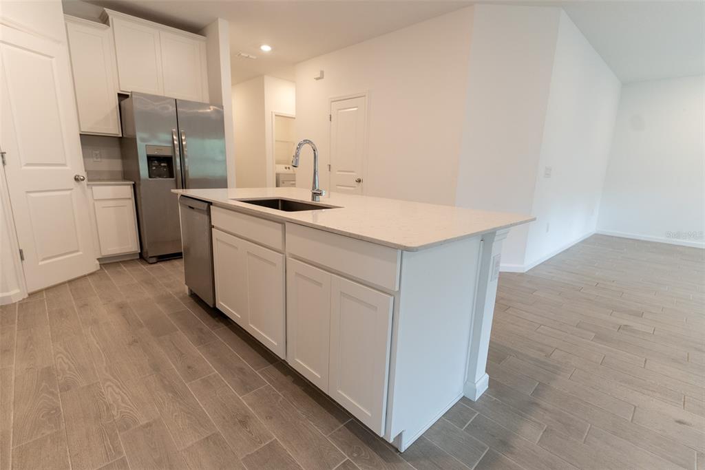 4501 Northwest 14th Loop Ocala, FL 34482 - Photo 21 of 38 a kitchen with a sink cabinets and stainless steel appliances