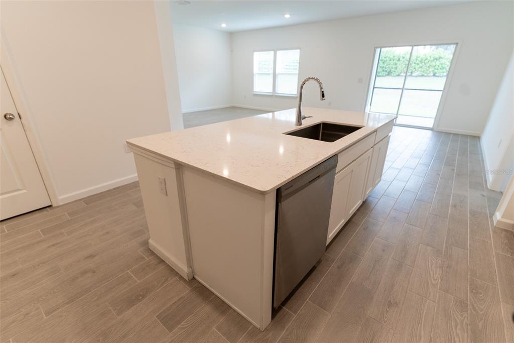 4501 Northwest 14th Loop Ocala, FL 34482 - Photo 24 of 38 a kitchen with a wooden floor and window