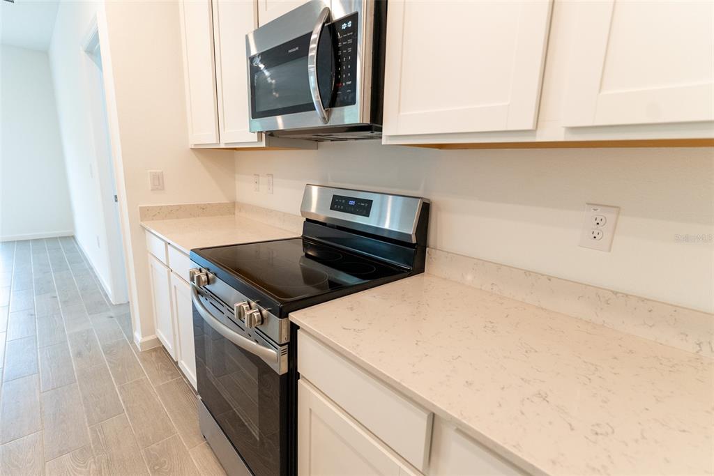 4501 Northwest 14th Loop Ocala, FL 34482 - Photo 25 of 38 a kitchen with a sink and a stove top oven
