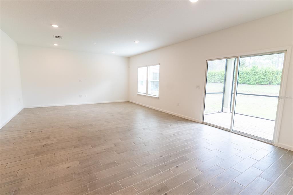 4501 Northwest 14th Loop Ocala, FL 34482 - Photo 26 of 38 an empty room with wooden floor and windows