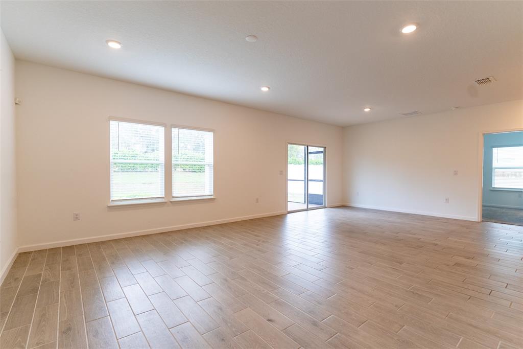 4501 Northwest 14th Loop Ocala, FL 34482 - Photo 27 of 38 an empty room with wooden floor and windows