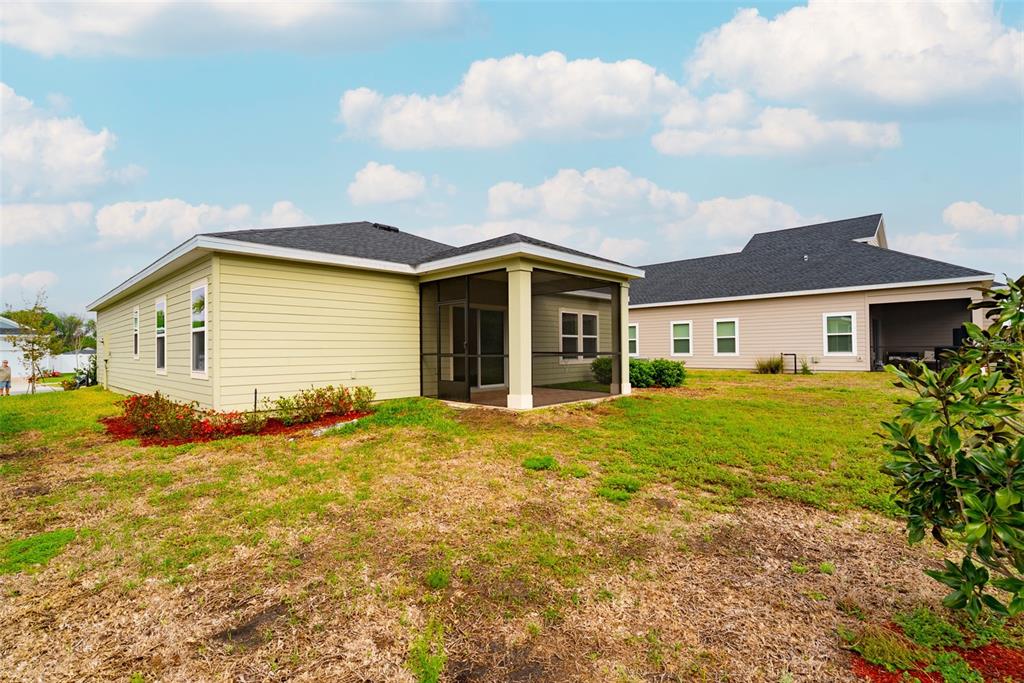 4501 Northwest 14th Loop Ocala, FL 34482 - Photo 31 of 38 a view of a yard in front of a house with a large tree