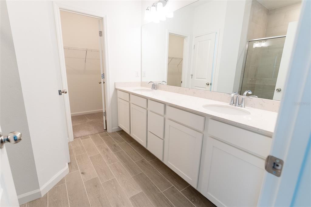 4501 Northwest 14th Loop Ocala, FL 34482 - Photo 5 of 38 a spacious bathroom with a double vanity sink and mirror