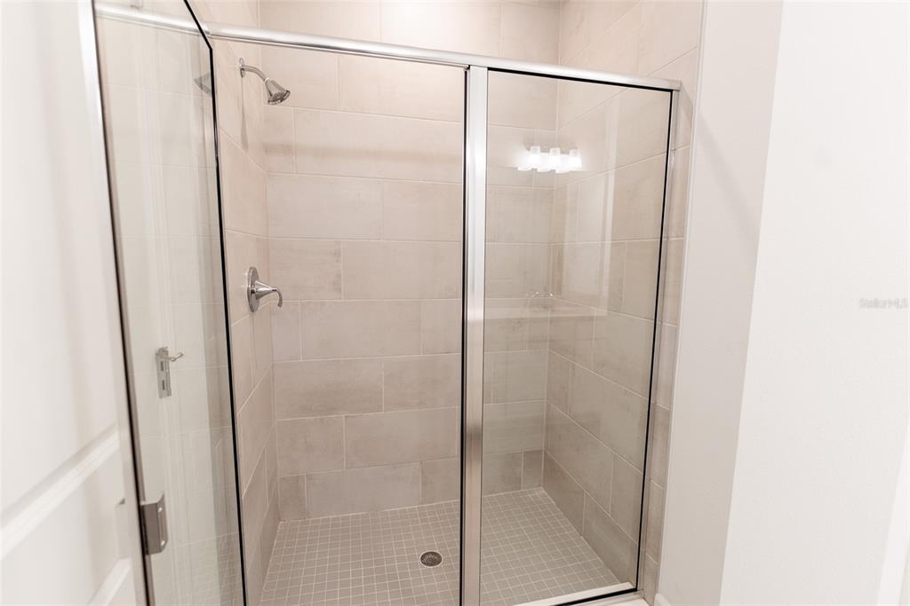 4501 Northwest 14th Loop Ocala, FL 34482 - Photo 6 of 38 a bathroom with a glass shower door