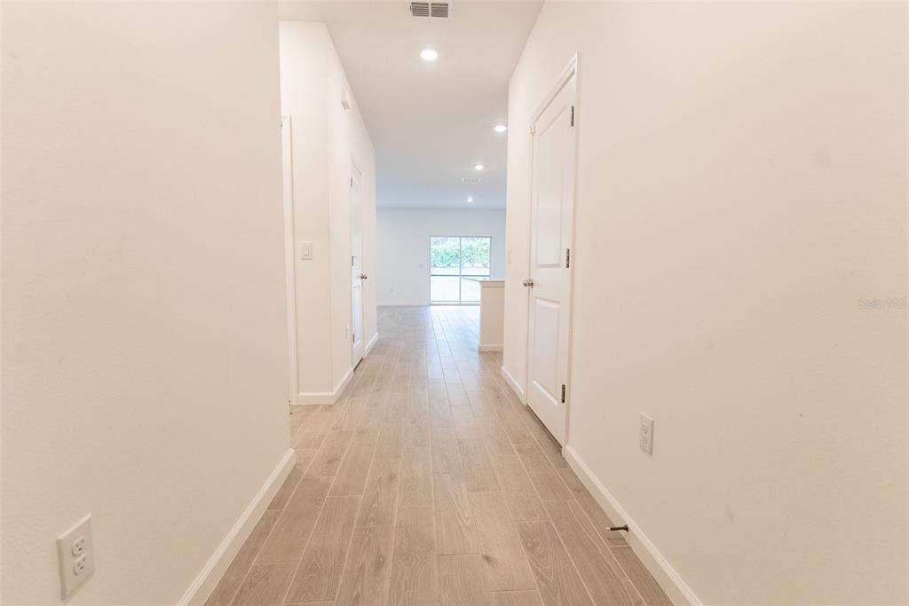 4501 Northwest 14th Loop Ocala, FL 34482 - Photo 9 of 38 a view of a hallway with wooden floor