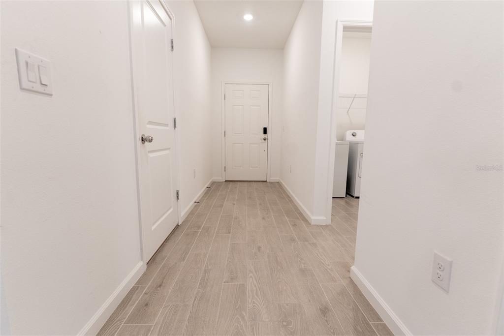 4501 Northwest 14th Loop Ocala, FL 34482 - Photo 10 of 38 a view of a hallway with wooden floor