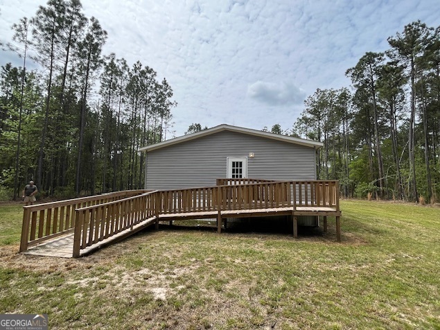 26 Ebenezer Church Road Swainsboro, GA 30401 - Photo 2 of 11 a view of a house with a yard and a large tree