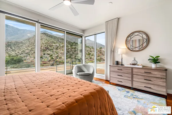 a bedroom with a bed lamp and a window