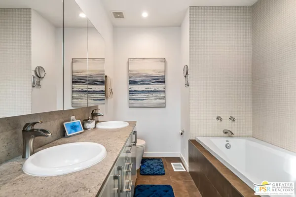 a bedroom with a bed and a painting on the wall