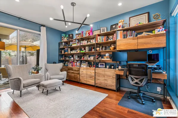 a reading room with furniture wooden floor and a book shelf