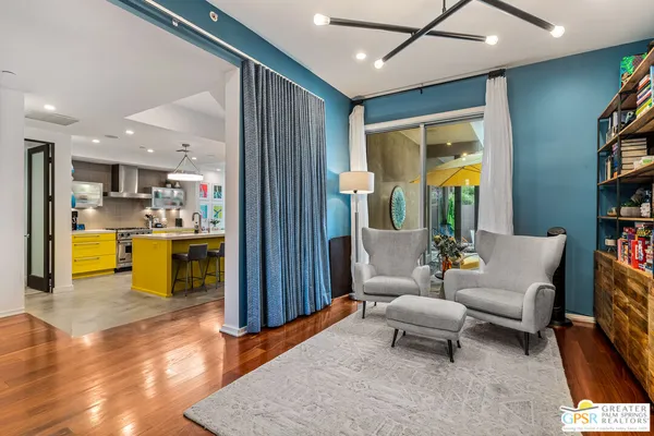 a living room with furniture and kitchen view