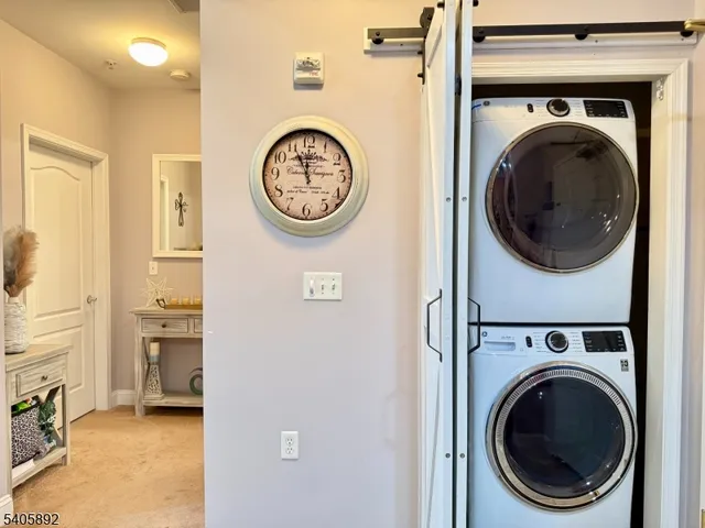 a view of a hallway with washer and dryer