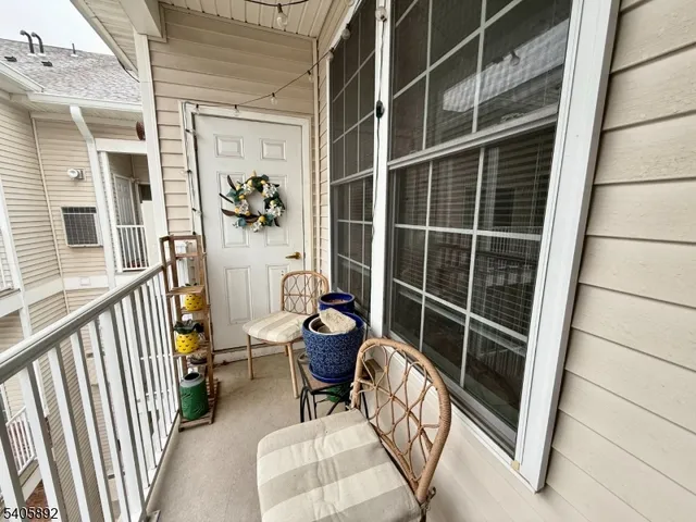 a view of a balcony with chair and wooden floor