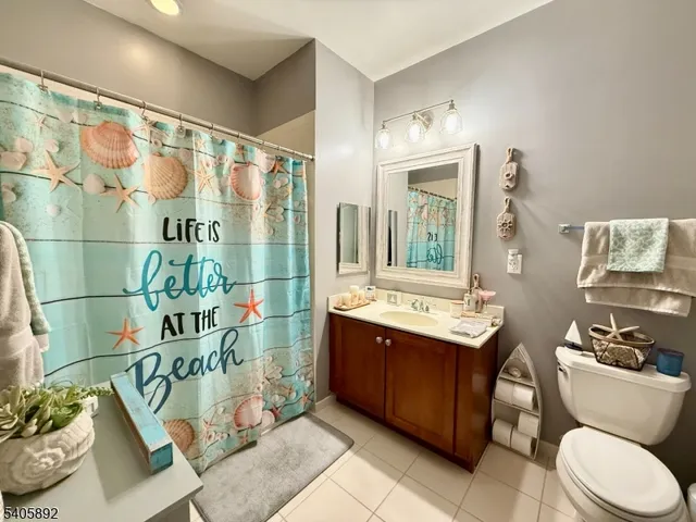 a bathroom with a sink mirror vanity and toilet