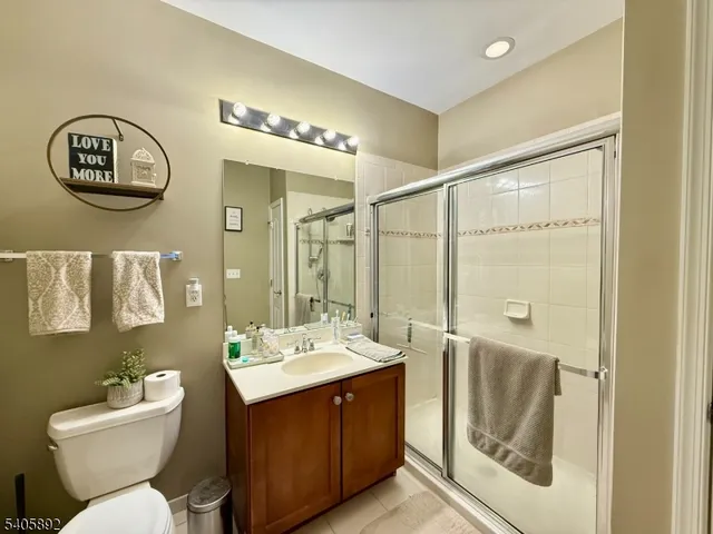 a bathroom with a double vanity sink mirror and toilet