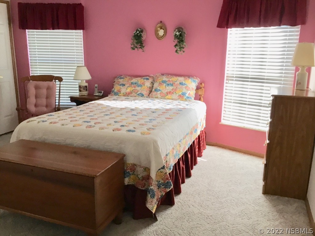 752 Navigators Way Edgewater, FL 32141 - Photo 8 of 14 a bedroom with a bed and a window