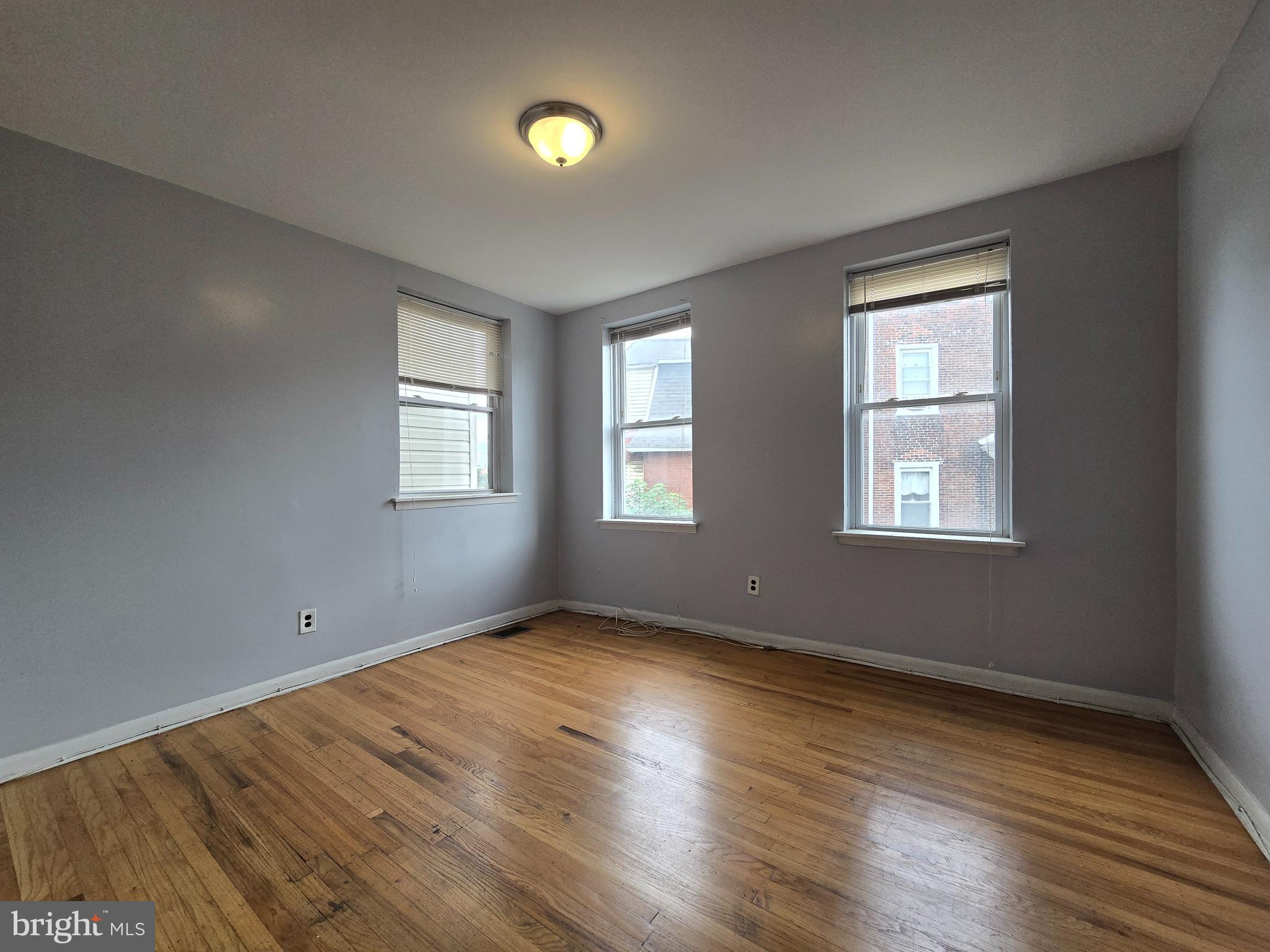623 North 32nd Street, Unit 2 Philadelphia, PA 19104 - Photo 11 of 12 a view of an empty room with wooden floor and a window