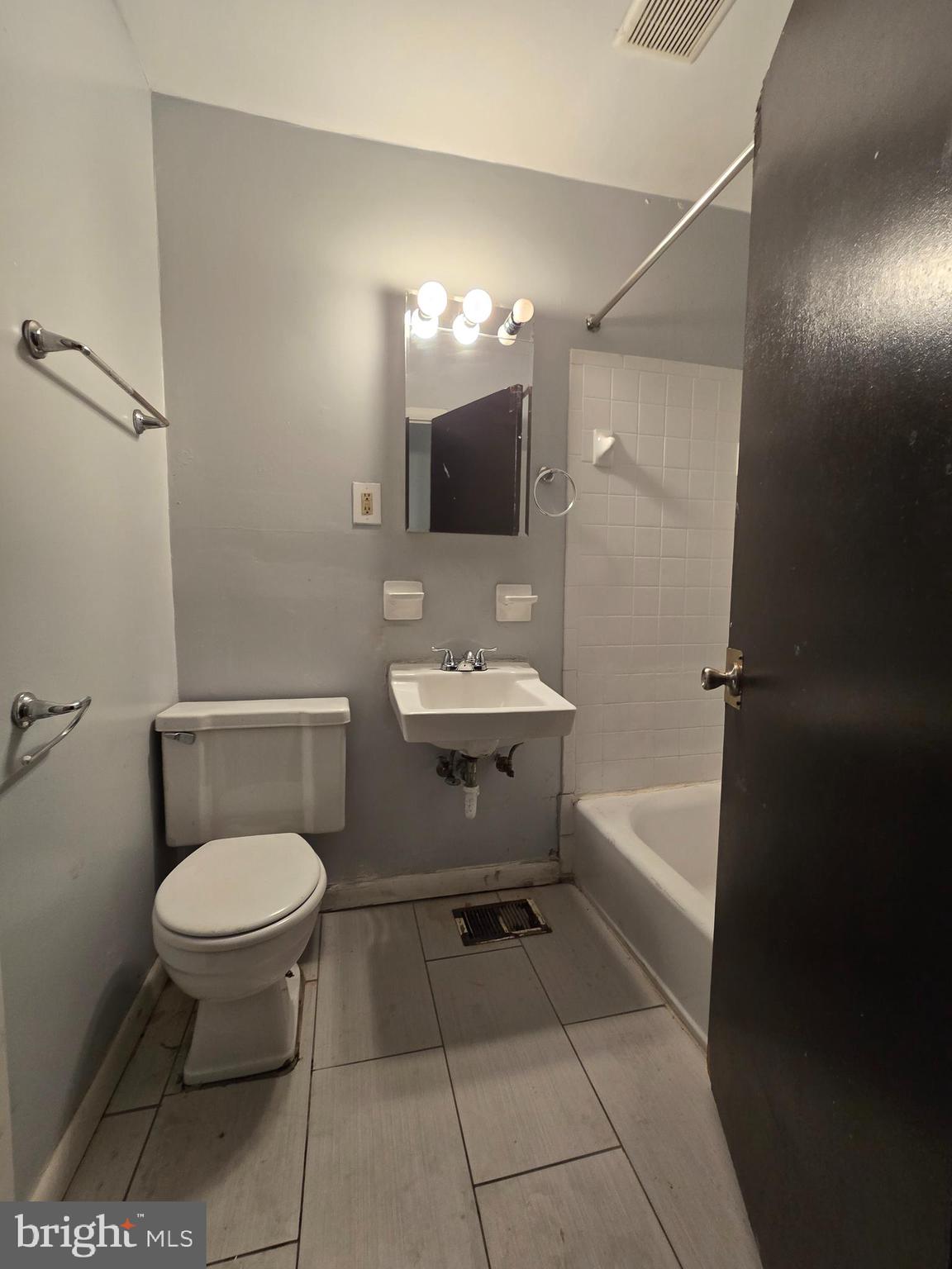 623 North 32nd Street, Unit 2 Philadelphia, PA 19104 - Photo 7 of 12 a bathroom with a toilet a sink and mirror