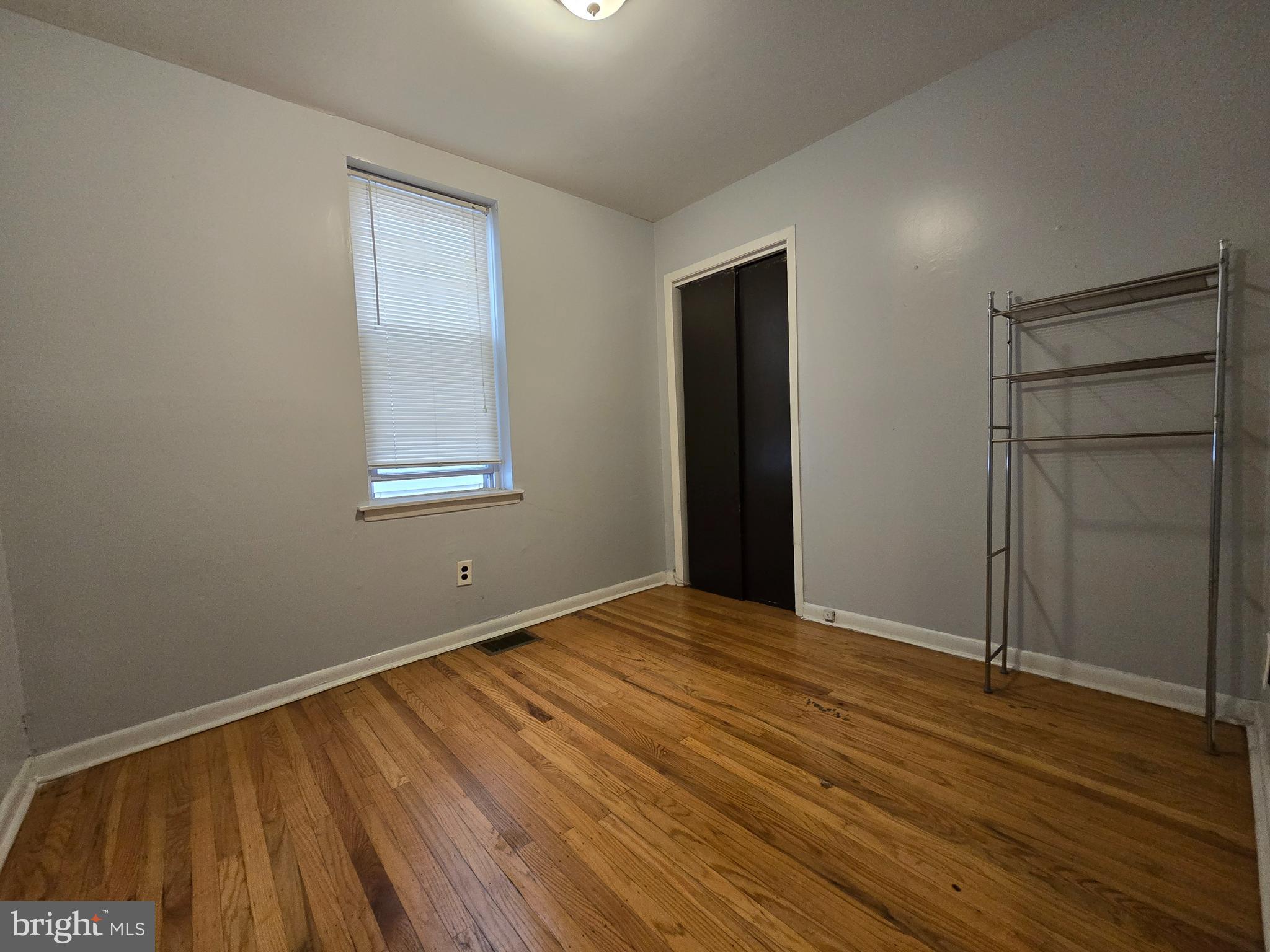 623 North 32nd Street, Unit 2 Philadelphia, PA 19104 - Photo 9 of 12 a view of an empty room with wooden floor and a window