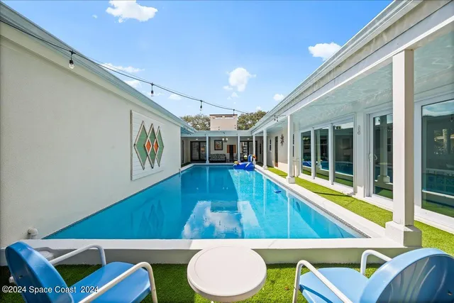 a view of a dining room with furniture wooden floor and chandelier
