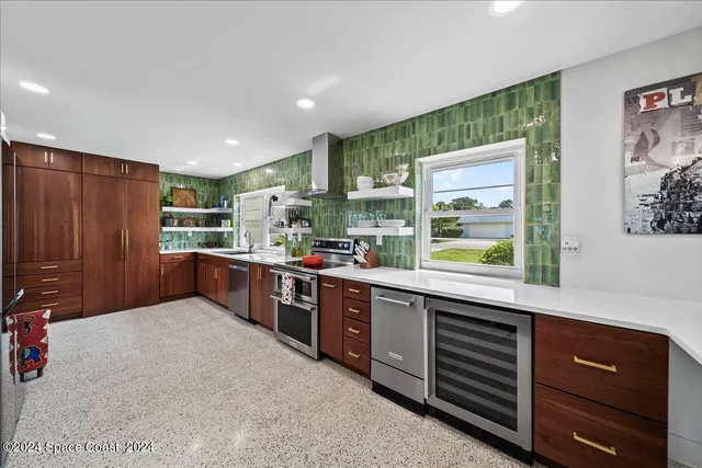 a kitchen with stainless steel appliances granite countertop a refrigerator and a sink