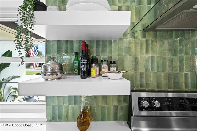 a kitchen with stainless steel appliances a sink a stove and a wooden floors