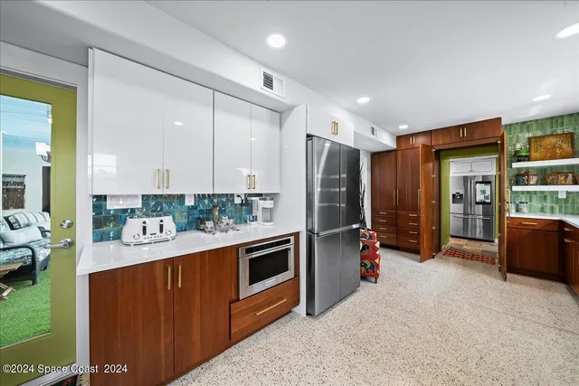 a large kitchen with a table and chairs