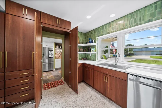 a open kitchen with stainless steel appliances granite countertop a stove and a refrigerator