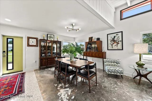 a bed sitting in a spacious bedroom next to a window