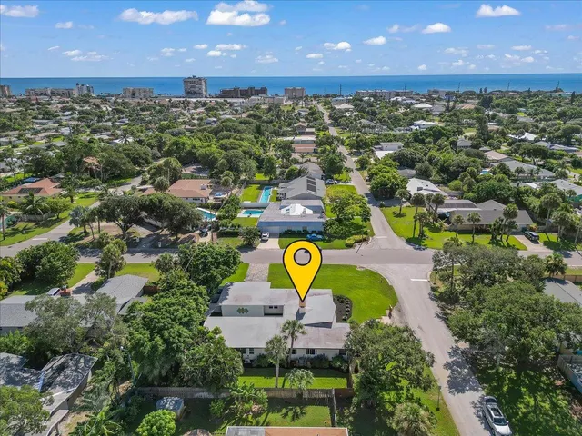 an aerial view of residential houses with swimming pool and outdoor space