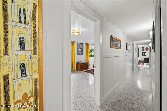 a living room filled with furniture and a large window