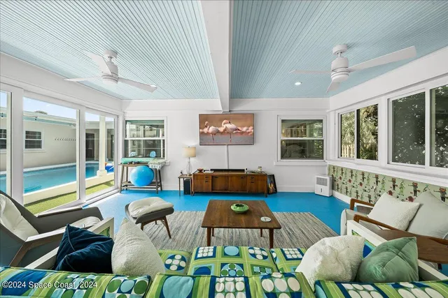 a balcony with wooden floor and outdoor seating