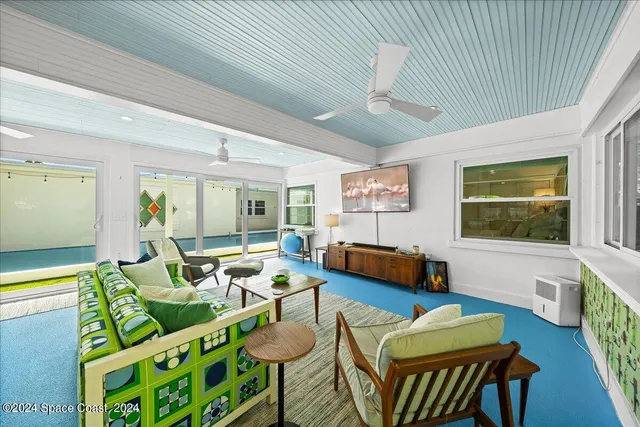 a view of a bedroom with furniture and windows