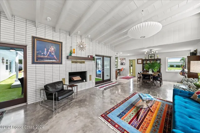 a living room with furniture a rug and a large window